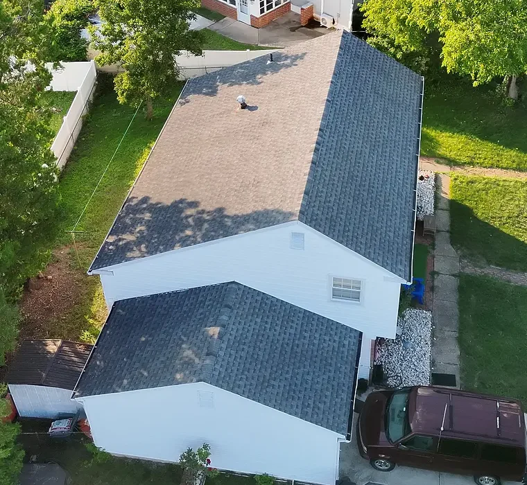 Oblique aerial overview of a residential property and its roof sections.